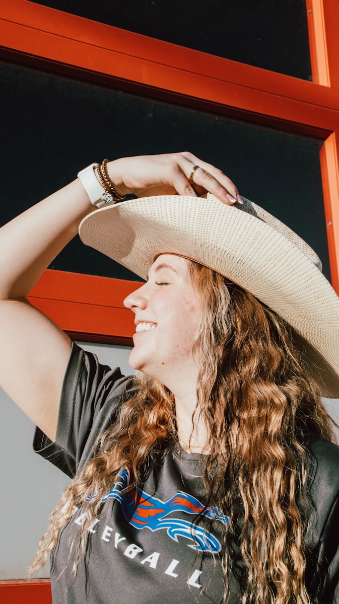 a woman with long hair wearing a cowboy hat